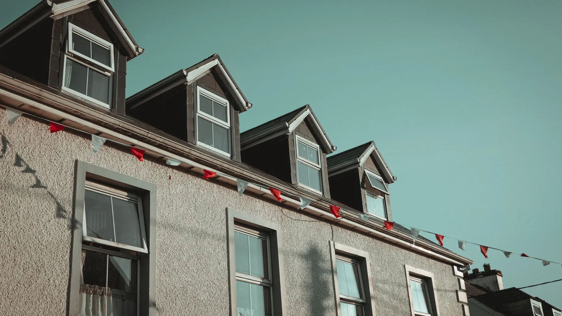 Row of dormer windows in the roof of a terrace of houses