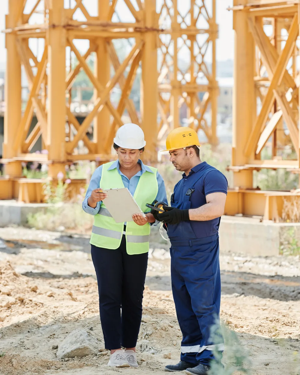 Site professional reviewing drawings on a building site
