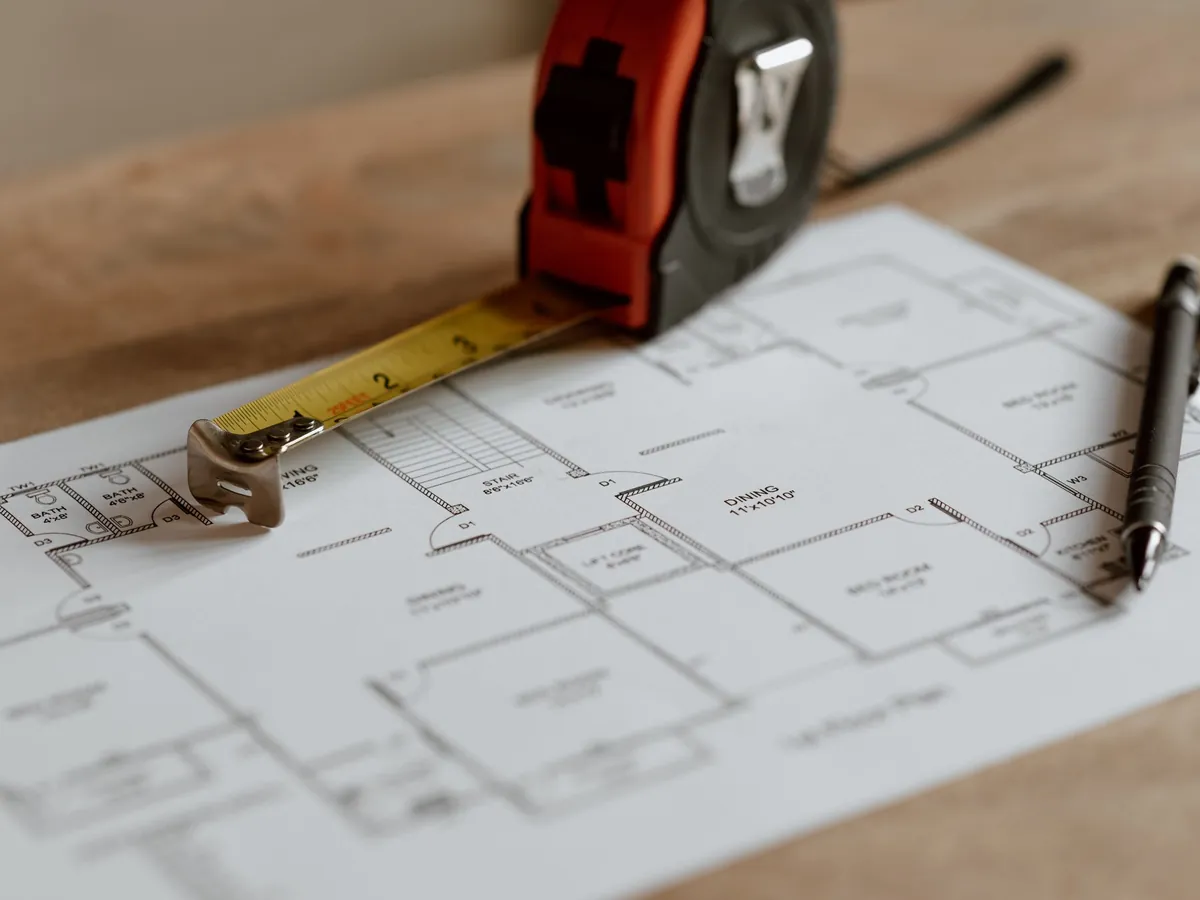 Tape measure resting on a set of drawings