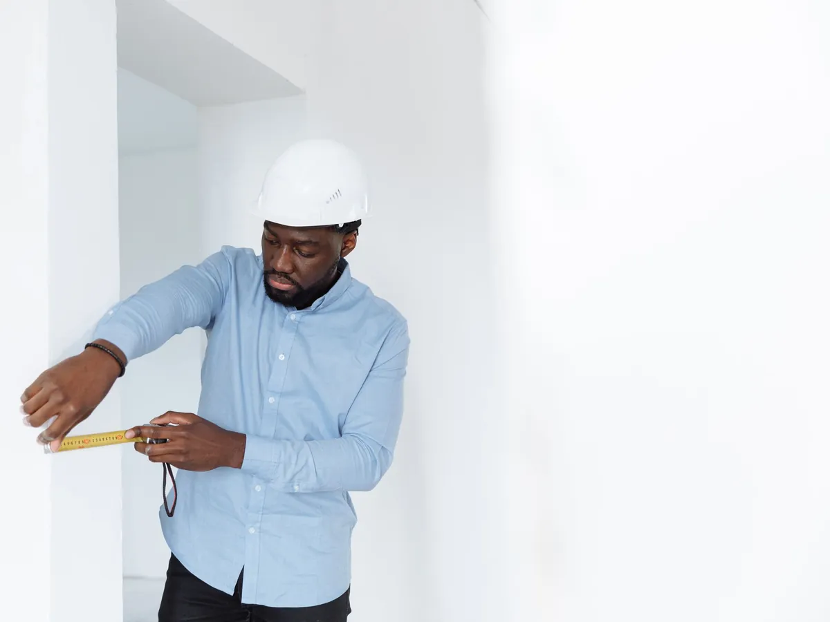 Tape measure pulled out across a room during a site visit