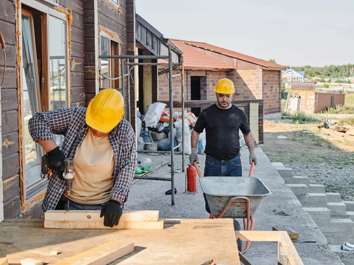 Builders working on a house under construction